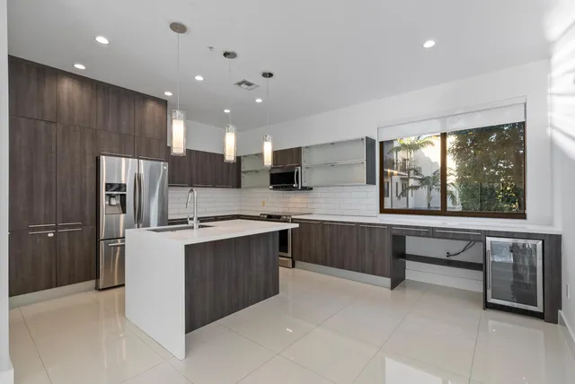 a kitchen with stainless steel appliances a sink stove and cabinets