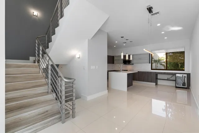 a kitchen that has a sink and a stove top oven
