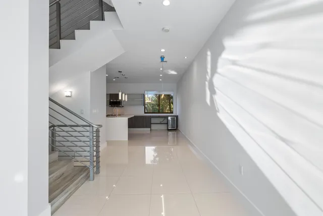 a view of a kitchen with a sink and a living room view