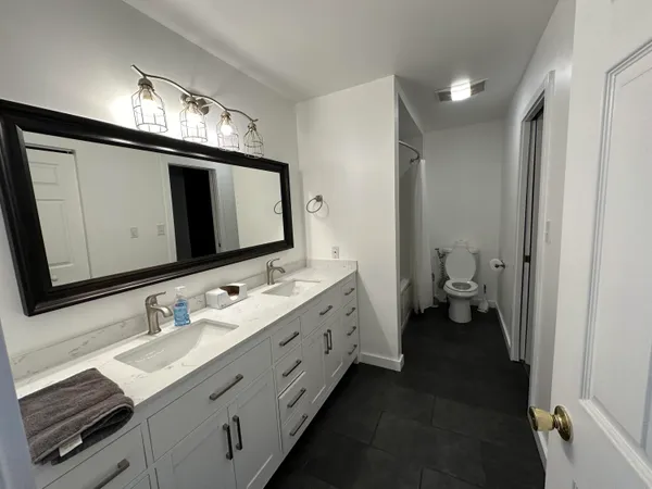 a bathroom with a tub a sink and a shower