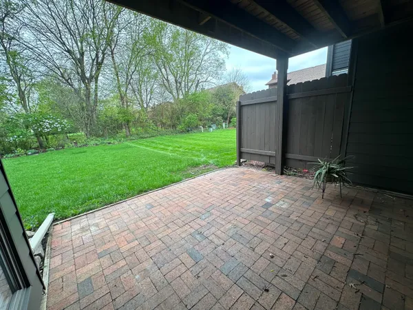 a view of a house with pool and a yard