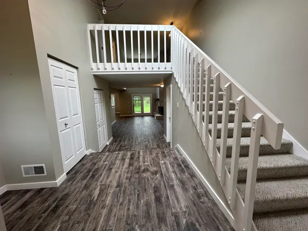 a view of entryway with wooden floor and stairs