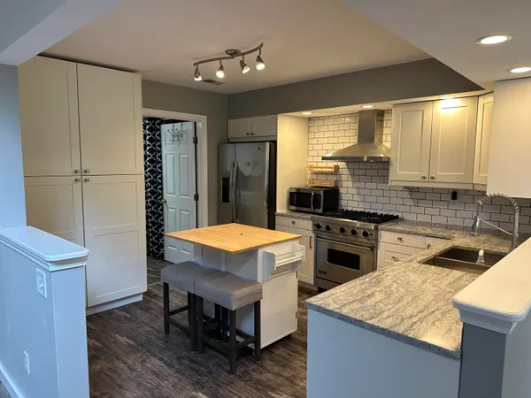 a kitchen with a stove a sink a refrigerator and a cabinets