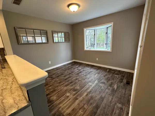 a view of an empty room with windows