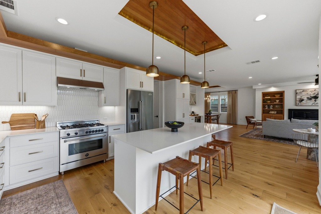 1301 Madison Avenue Austin, TX 78757 - Photo 13 of 39 a kitchen with granite countertop a stove a sink and a refrigerator