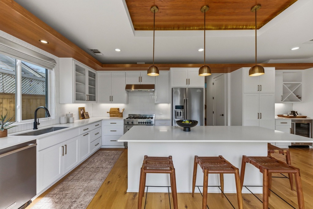 1301 Madison Avenue Austin, TX 78757 - Photo 14 of 39 a large kitchen with kitchen island a large island in the center