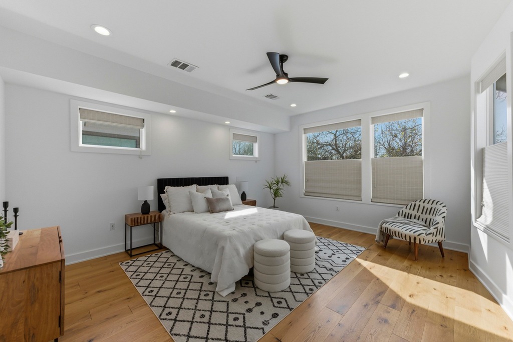 1301 Madison Avenue Austin, TX 78757 - Photo 20 of 39 a spacious bedroom with a bed and a couch