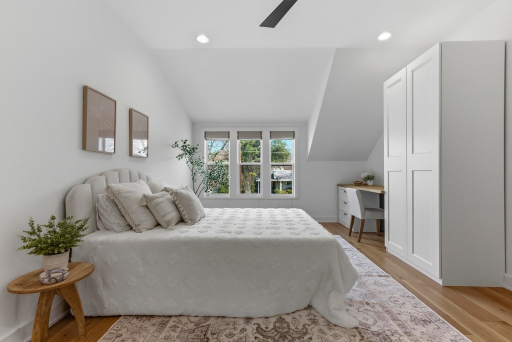 1301 Madison Avenue Austin, TX 78757 - Photo 30 of 39 a large bed sitting in a bedroom next to a window and a chair