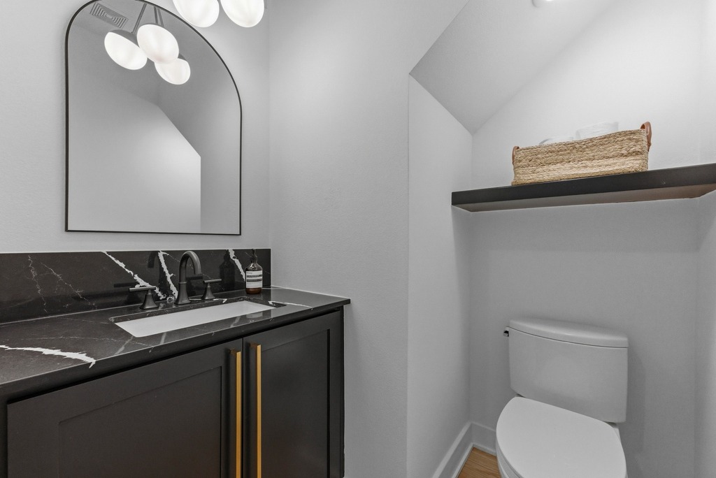 1301 Madison Avenue Austin, TX 78757 - Photo 31 of 39 a bathroom with a sink vanity mirror and toilet