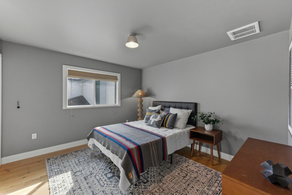 1301 Madison Avenue Austin, TX 78757 - Photo 32 of 39 a bedroom with a bed and wooden floor