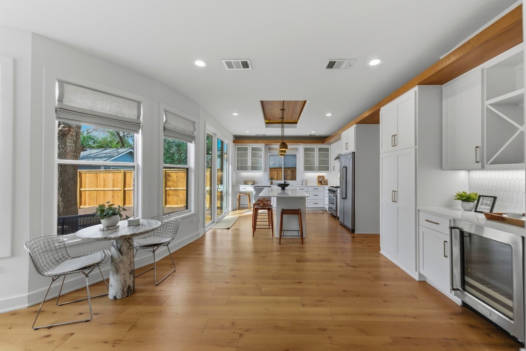 1301 Madison Avenue Austin, TX 78757 - Photo 7 of 39 a view of a kitchen with dining room and wooden floor