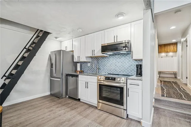 a kitchen with a stove microwave and refrigerator