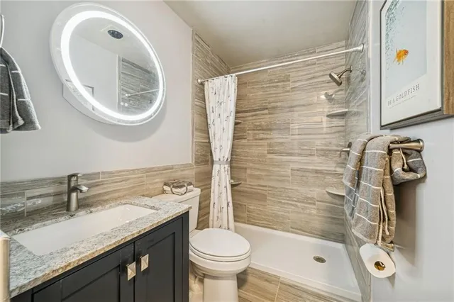 a bathroom with a sink a toilet and a mirror