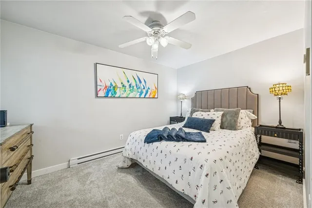 a bedroom with a bed and ceiling fan