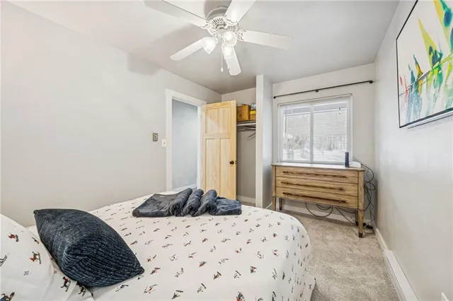 a bedroom with a bed dresser and a window