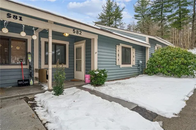 a view of a patio with a table and chairs under an umbrella