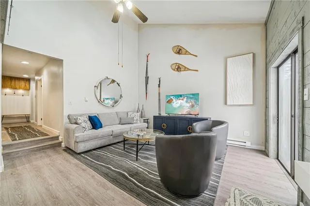 a living room with furniture and a chandelier