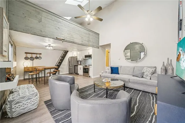 a living room with furniture and a chandelier