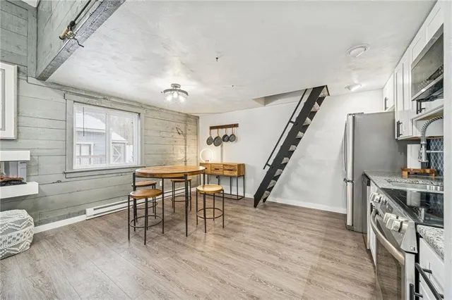 a view of a dining room with furniture and a wooden floor