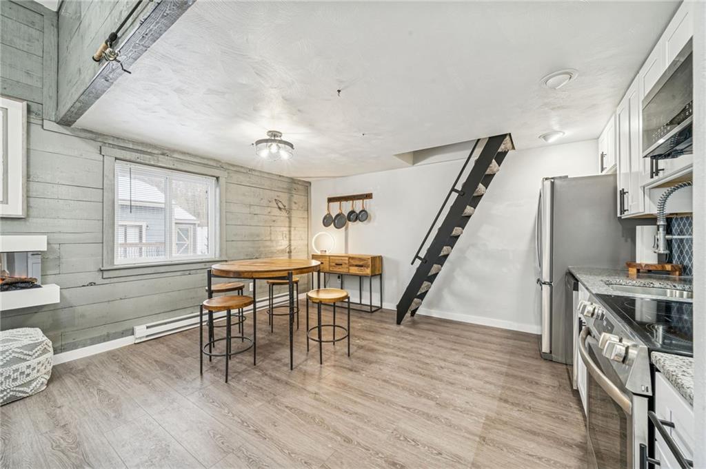 582 Maple Court Hidden Valley, PA 15502 - Photo 7 of 38 a view of a dining room with furniture and a wooden floor