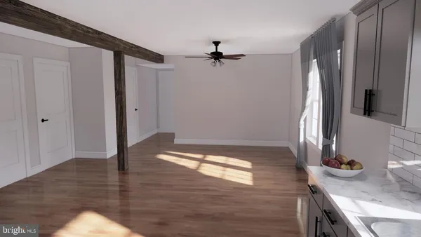 wooden floor in an empty room with a window