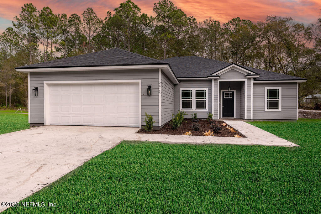 2491 Marigold Avenue Middleburg, FL 32068 - Photo 1 of 34 a front view of house with yard and green space