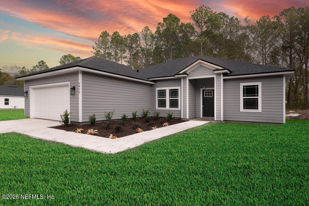 2491 Marigold Avenue Middleburg, FL 32068 - Photo 2 of 34 a front view of a house with a yard and garage