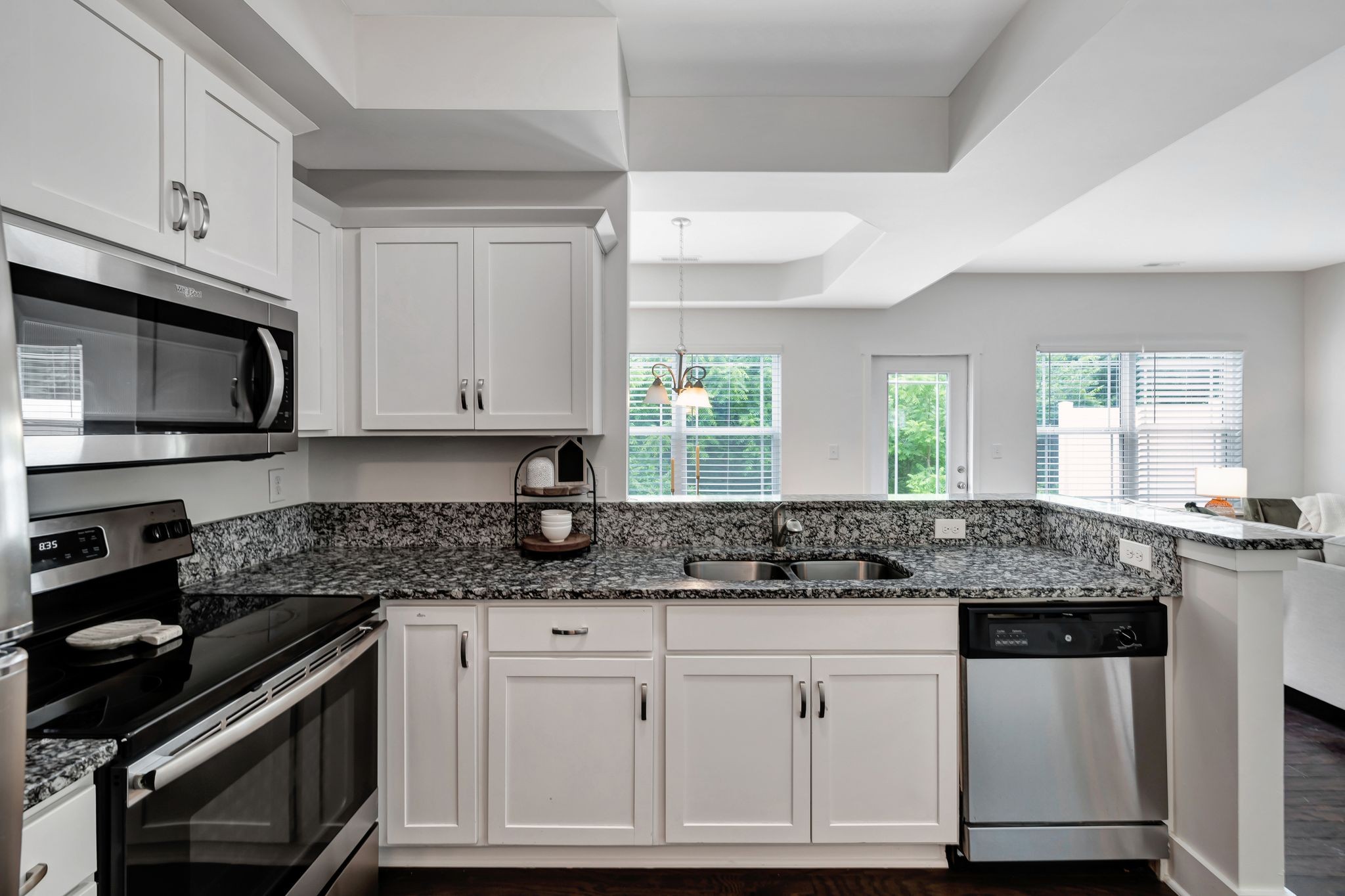 1134 Somerset Springs Drive Spring Hill, TN 37174 - Photo 11 of 28 a kitchen with granite countertop a sink stainless steel appliances and white cabinets