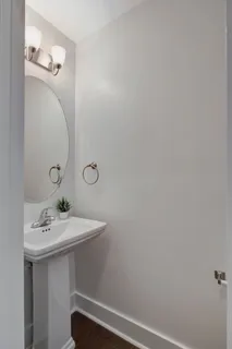 a bathroom with a sink a mirror and vanity
