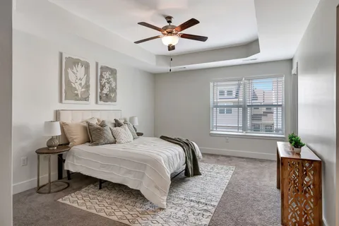 a bedroom with a bed and a chandelier
