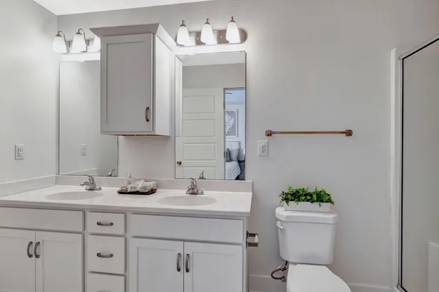 a bathroom with a sink toilet and mirror