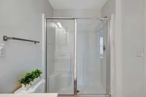 a bathroom with a glass shower door