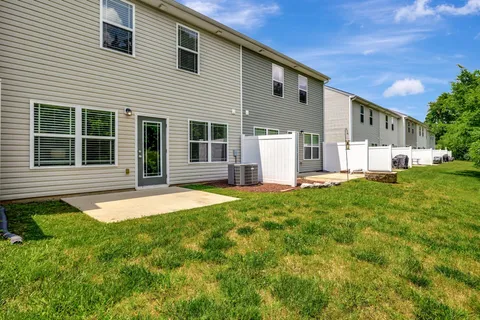 a front view of a house with a road
