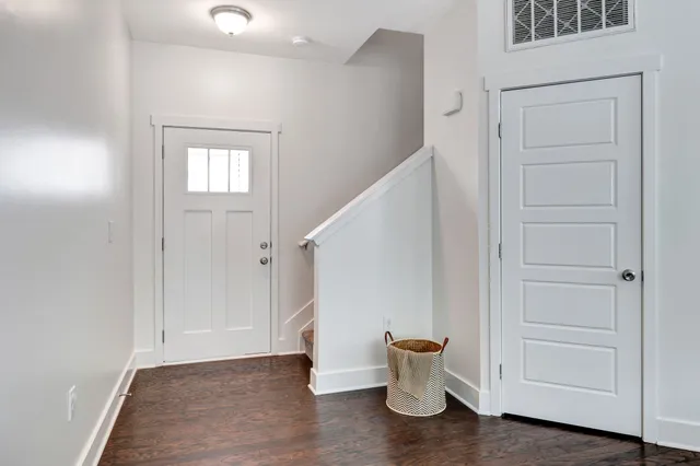 a view of a room with a potted plant and hallway