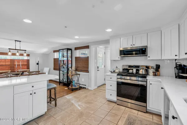 a kitchen with stainless steel appliances granite countertop a stove top oven a sink a counter space and cabinets