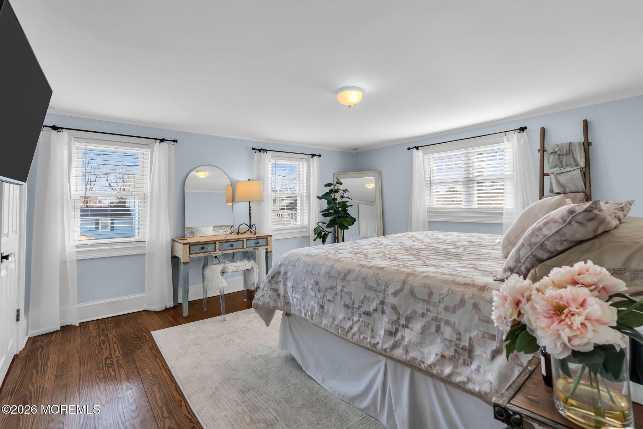 115 10th Avenue Spring Lake, NJ 07762 - Photo 22 of 30 a spacious bedroom with a bed and a dresser with mirror