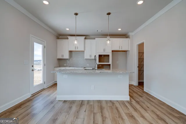 a bathroom with a granite countertop sink a toilet and shower