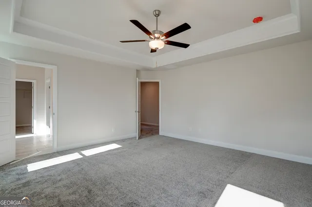 a sign board with tall buildings in the background