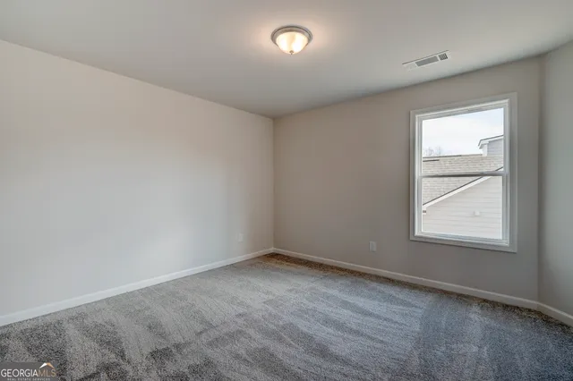 a view of empty room with wooden floor and fireplace