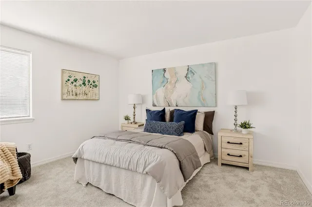 a bedroom with a bed and a couch