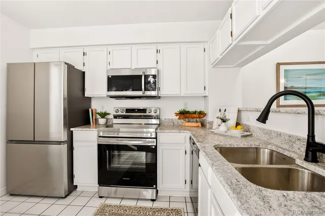 a kitchen with a sink cabinets and stainless steel appliances