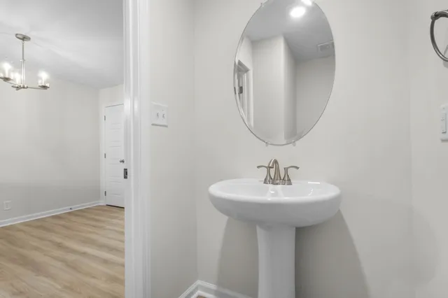 a bathroom with a sink a mirror and a vanity