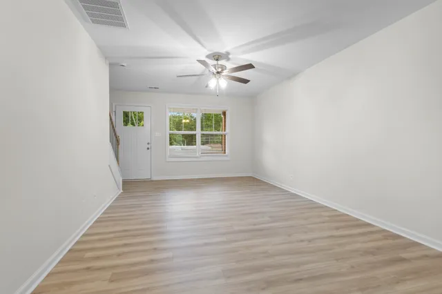wooden floor in an empty room with a window