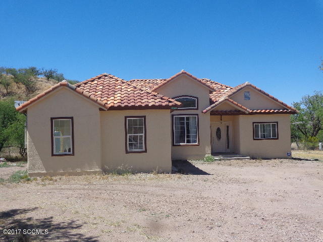 430 Churea Lane Rio Rico, AZ 85648 - Photo 1 of 14 a front view of a house with a yard