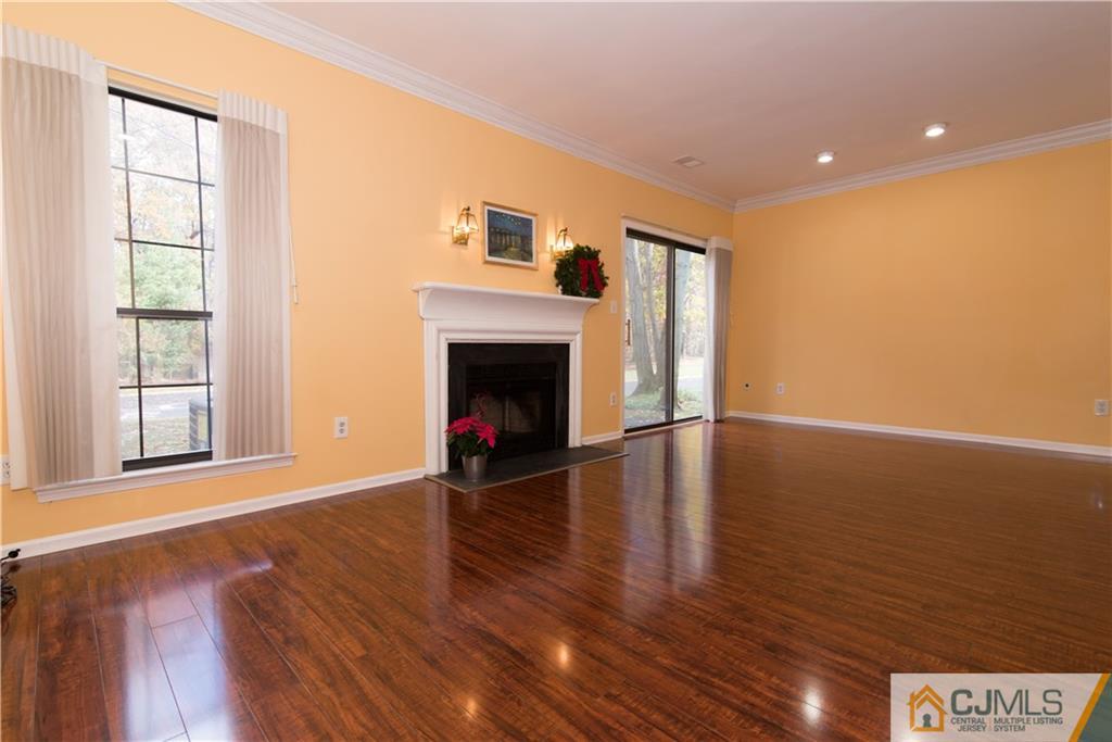 1106 Timber Oaks Road, Unit 1106 Edison, NJ 08820 - Photo 4 of 20 a view of an empty room with wooden floor and a window