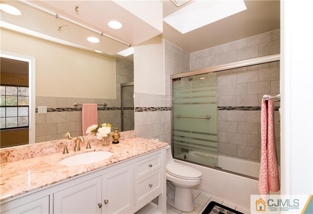 1106 Timber Oaks Road, Unit 1106 Edison, NJ 08820 - Photo 8 of 20 a bathroom with a granite countertop sink toilet and shower