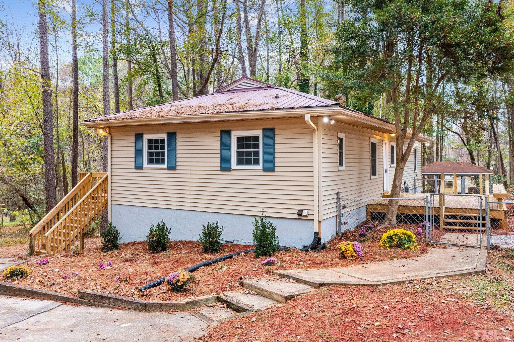 1124 Harper Road Raleigh, NC 27603 - Photo 3 of 59 a front view of a house with a yard