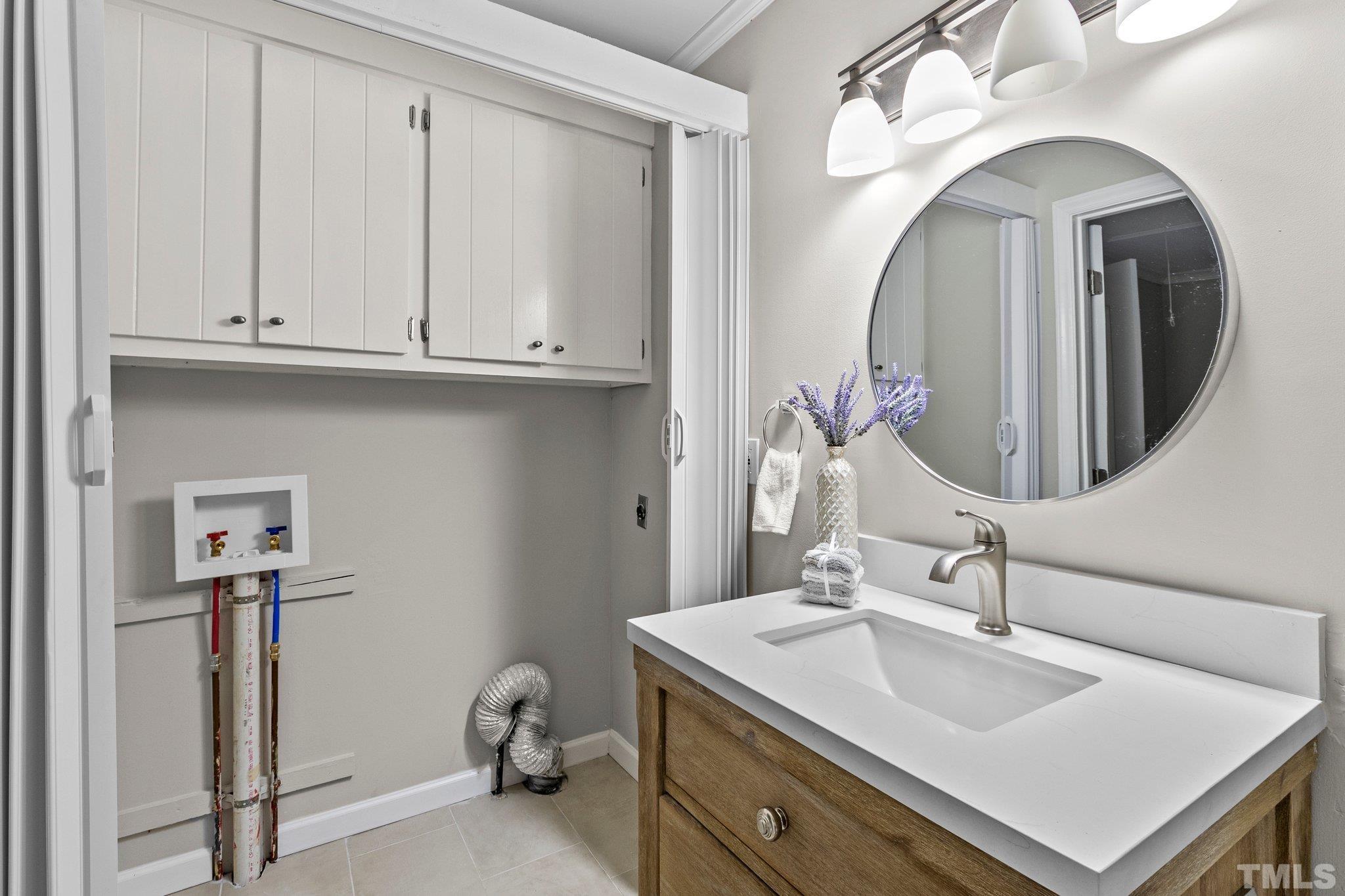 1124 Harper Road Raleigh, NC 27603 - Photo 46 of 59 a bathroom with a sink and a mirror