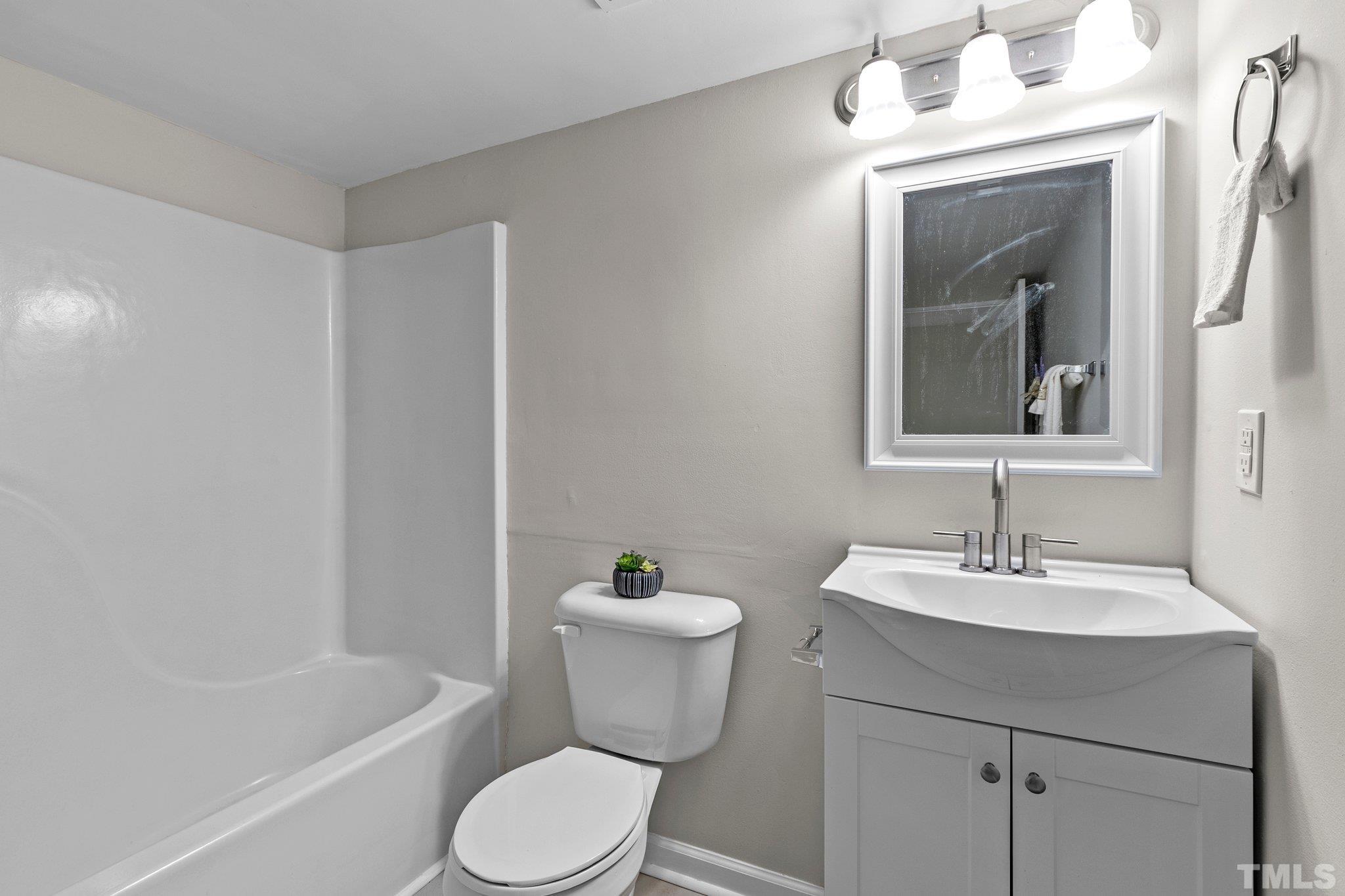 1124 Harper Road Raleigh, NC 27603 - Photo 54 of 59 a bathroom with a sink toilet and shower