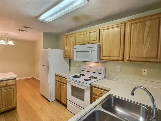 a kitchen with stainless steel appliances a stove a microwave and a refrigerator